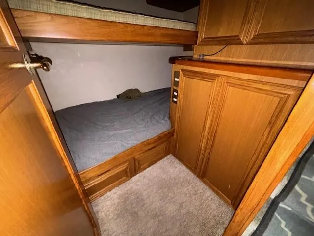 Slide: The Image of 2007 Jersey Cape 44 CNV cabin interior with wooden bunk beds and storage cabinets. - 38