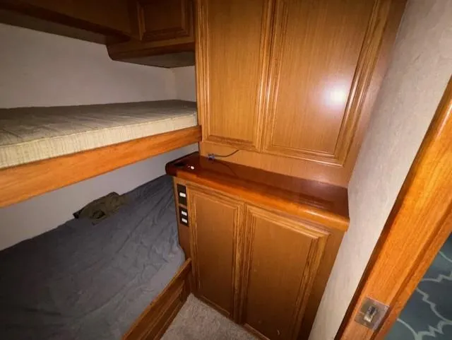 Slide: The Image of Interior of 2007 Jersey Cape 44 CNV with wooden cabinets and bunk beds. - 40