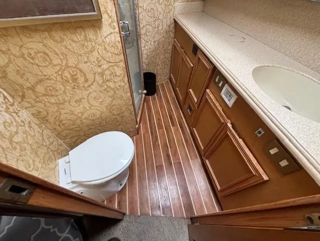 Slide: The Image of Bathroom interior of 2007 Jersey Cape 44 CNV with wood flooring and elegant wallpaper. - 43
