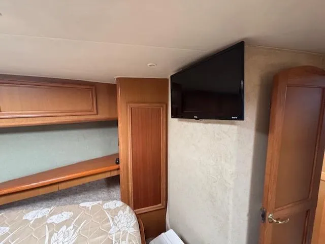 Slide: The Image of Interior of 2007 Jersey Cape 44 CNV with TV and wooden cabinetry. - 48