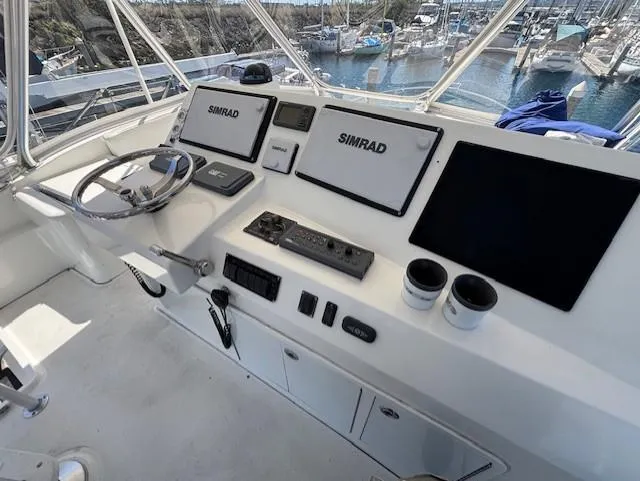 Slide: The Image of 2007 Jersey Cape 44 CNV helm with Simrad navigation system and marina view. - 8