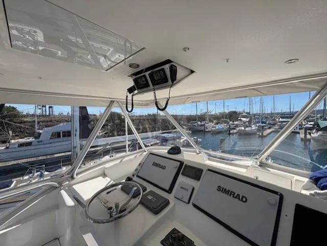 Slide: The Image of 2007 Jersey Cape 44 CNV boat helm with Simrad navigation, docked at marina. - 9