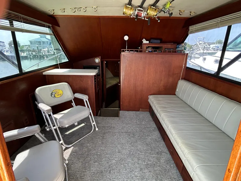 Slide: The Image of Interior of 1990 Albemarle 325 Convertible boat with seating and fishing gear. - 10