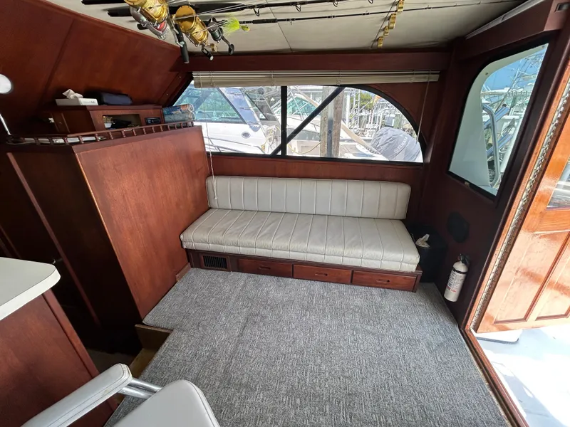Slide: The Image of Interior of 1990 Albemarle 325 Convertible boat with seating and fishing rods. - 11