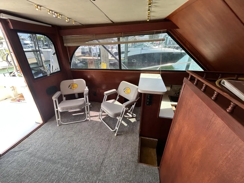 Slide: The Image of Interior of 1990 Albemarle 325 Convertible boat with chairs and wood paneling. - 12