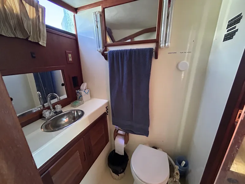 Slide: The Image of Bathroom interior of 1990 Albemarle 325 Convertible boat with sink and toilet. - 16
