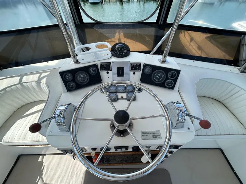 Slide: The Image of 1990 Albemarle 325 Convertible boat helm with steering wheel and instrument panel. - 19
