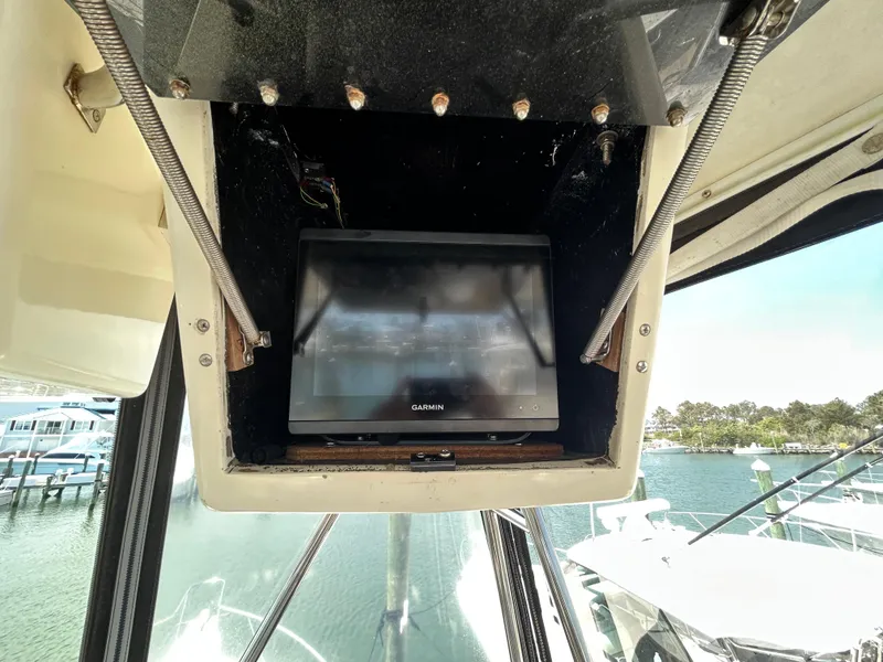Slide: The Image of 1990 Albemarle 325 Convertible boat with a mounted Garmin screen in the cockpit. - 20
