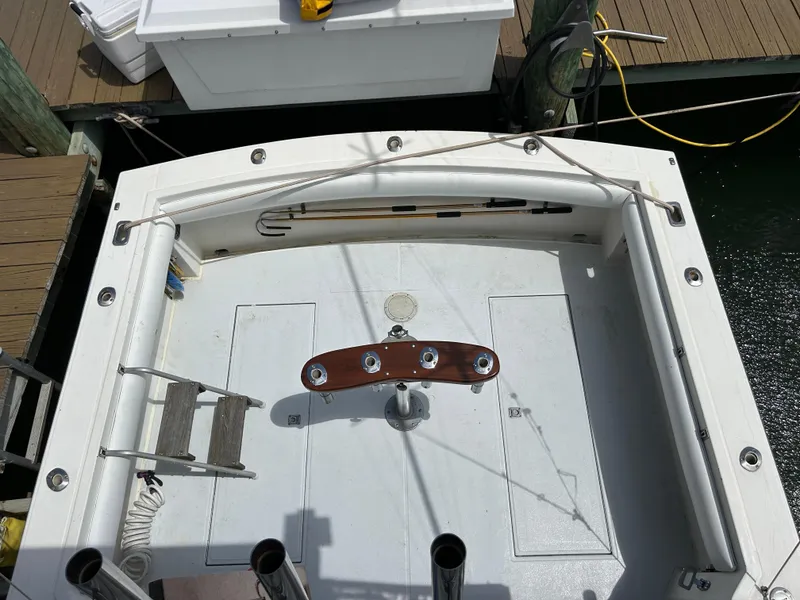 Slide: The Image of 1990 Albemarle 325 Convertible boat deck with fishing rod holders and ladder. - 21