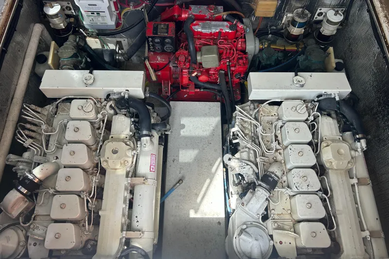 Slide: The Image of Engine room of a 1990 Albemarle 325 Convertible with dual engines and red generator. - 24