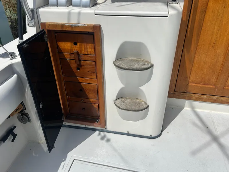 Slide: The Image of 1990 Albemarle 325 Convertible interior with open wooden storage cabinet and steps. - 9