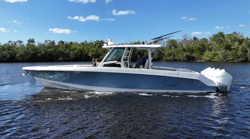 Slide: The Image of 2021 Boston Whaler 380 Outrage cruising on a sunny day with clear skies. - 2