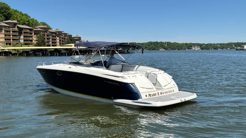 Slide: The Image of 2005 Regal 3350 Sport Cruiser on a lake with scenic background. - 13