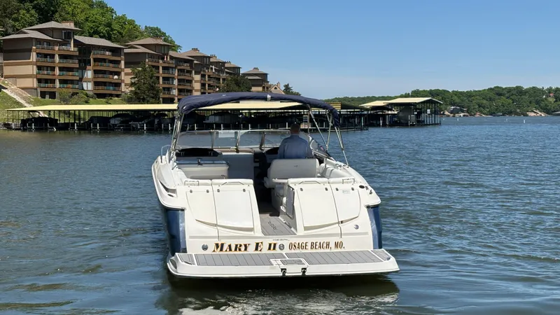Slide: The Image of 2005 Regal 3350 Sport Cruiser on lake near Osage Beach, MO, with waterfront buildings. - 14