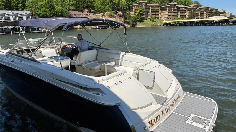 Slide: The Image of 2005 Regal 3350 Sport Cruiser on a scenic lake with waterfront homes. - 17
