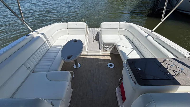 Slide: The Image of 2005 Regal 3350 Sport Cruiser interior with white seating and table on water. - 19