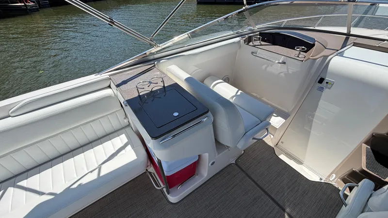 Slide: The Image of 2005 Regal 3350 Sport Cruiser interior with seating and helm, docked by the water. - 22