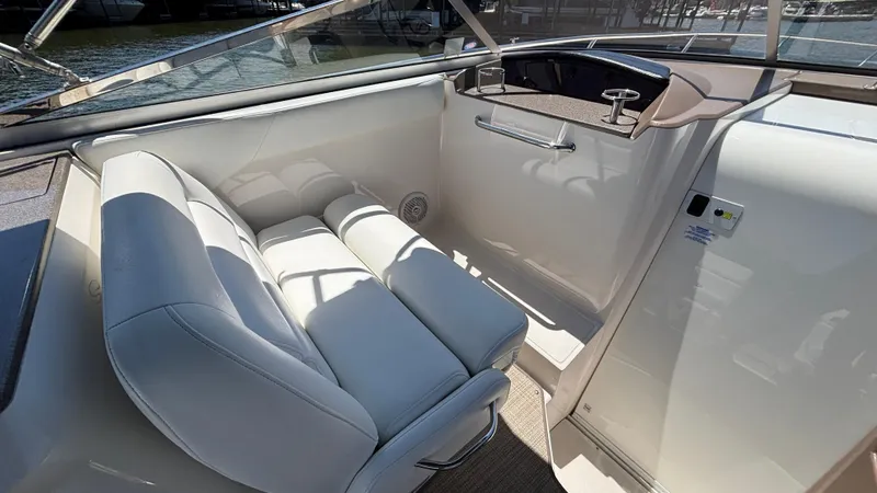 Slide: The Image of 2005 Regal 3350 Sport Cruiser interior with white seating and helm. - 25