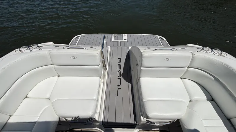 Slide: The Image of 2005 Regal 3350 Sport Cruiser with white seating and deck, on calm water. - 26