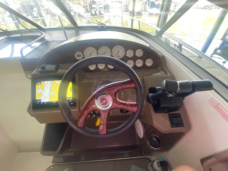 Slide: The Image of 2005 Regal 3350 Sport Cruiser dashboard with steering wheel and navigation system. - 27