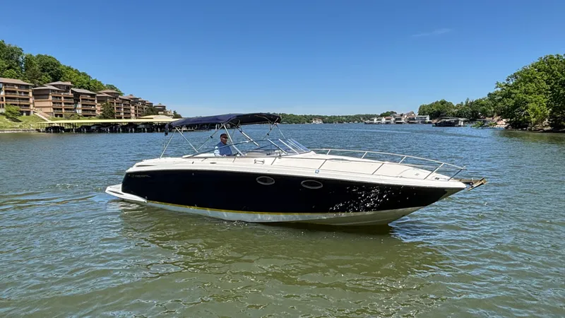 Slide: The Image of 2005 Regal 3350 Sport Cruiser on a scenic lake with clear blue skies. - 4