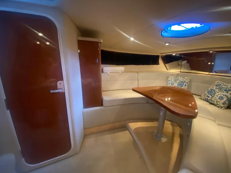Slide: The Image of Interior of 2005 Regal 3350 Sport Cruiser with plush seating and wooden table. - 43