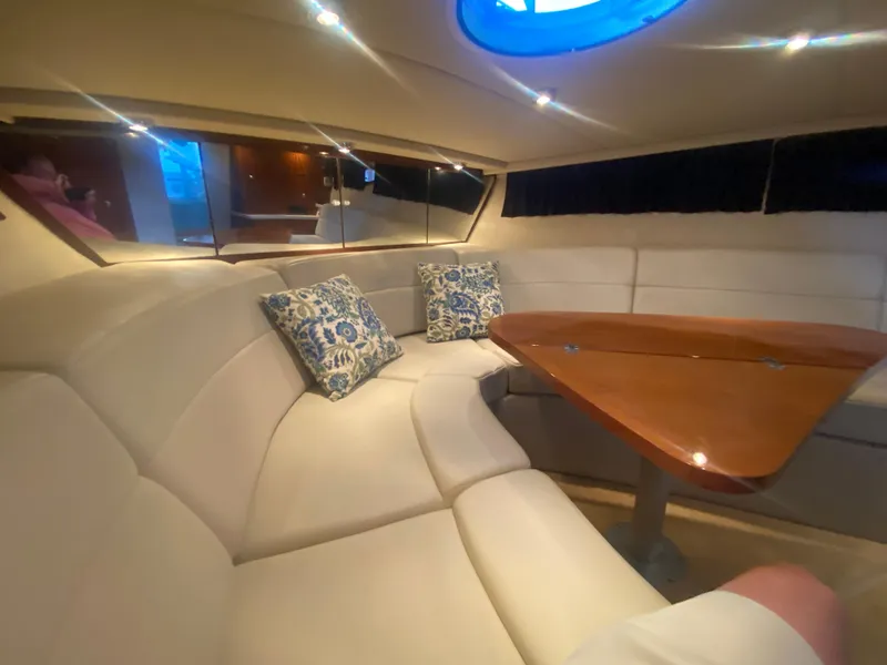 Slide: The Image of Interior of 2005 Regal 3350 Sport Cruiser with plush seating and wooden table. - 44