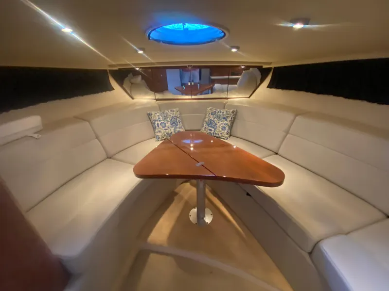 Slide: The Image of Luxurious interior of 2005 Regal 3350 Sport Cruiser with elegant seating and wooden table. - 46