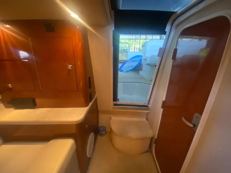 Slide: The Image of 2005 Regal 3350 Sport Cruiser interior with wood cabinetry and window view. - 47