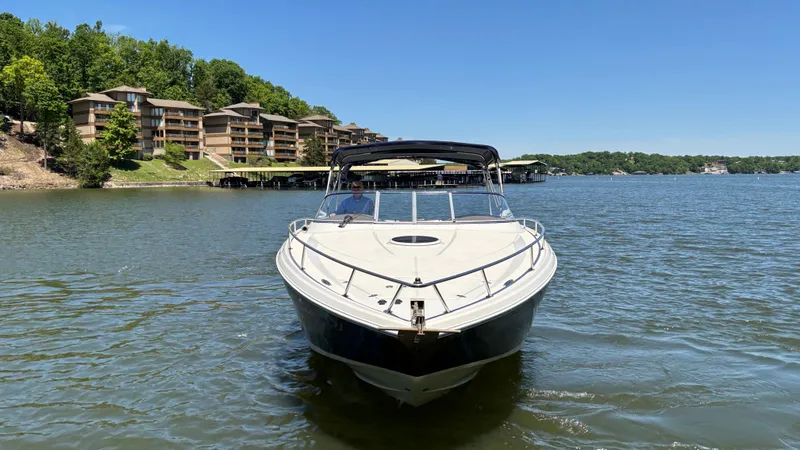 Slide: The Image of 2005 Regal 3350 Sport Cruiser on a lake with waterfront buildings in the background. - 7
