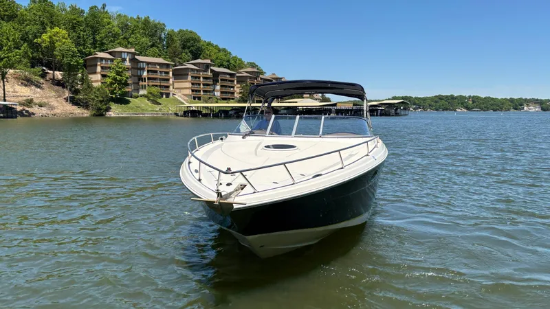 Slide: The Image of 2005 Regal 3350 Sport Cruiser on a scenic lake with waterfront buildings. - 8