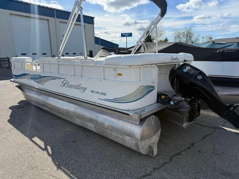 Slide: The Image of 2008 Bentley Pontoons 180 CRUISE boat with outboard motor, parked outdoors. - 4