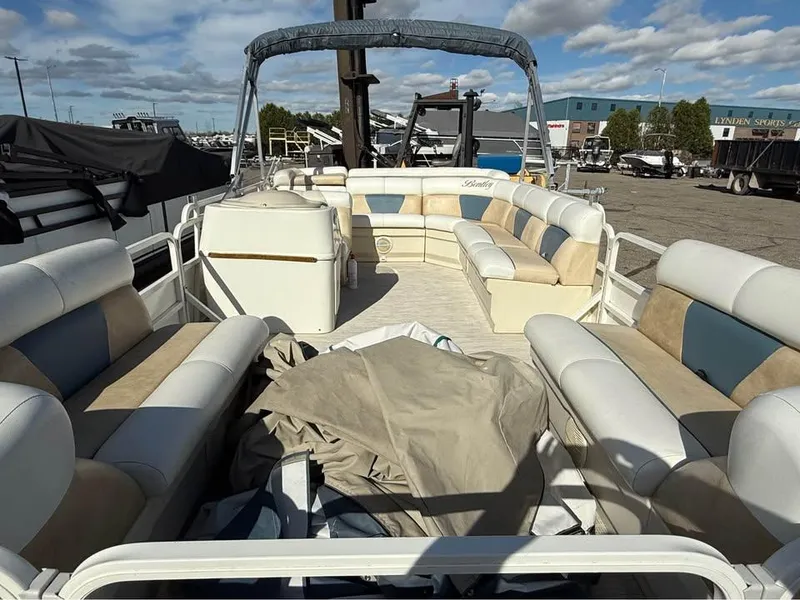 Slide: The Image of 2008 Bentley Pontoons 180 CRUISE with spacious seating, parked outdoors under a blue sky. - 6