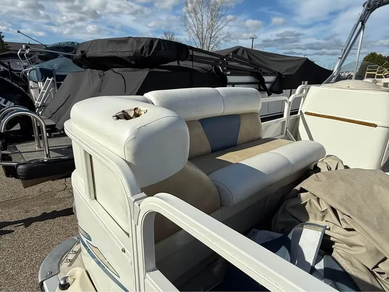 Slide: The Image of 2008 Bentley Pontoons 180 CRUISE with white seating, stored outdoors under a cloudy sky. - 7