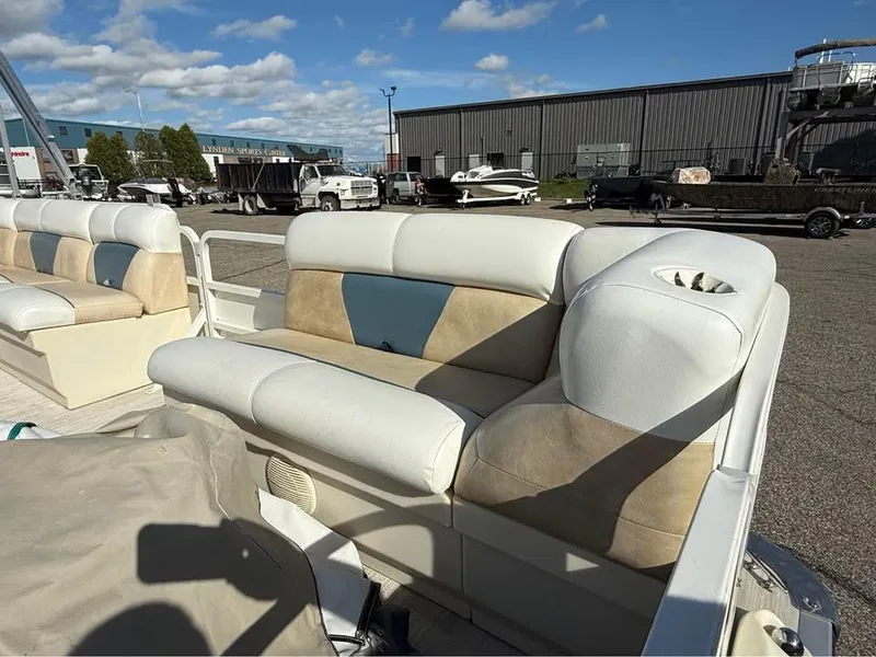 Slide: The Image of 2008 Bentley Pontoons 180 CRUISE interior seating with beige and blue accents, outdoor setting. - 8