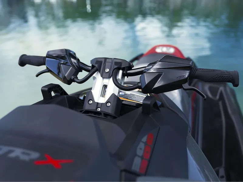 Slide: The Image of 2024 Sea-Doo GTR-X 300 iBR with sound system, handlebars view over water. - 3