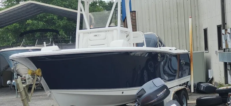 Slide: The Image of 2016 Sea Hunt Ultra 225 boat on trailer, parked outdoors near a building. - 1