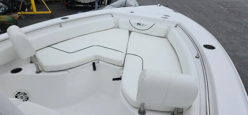 Slide: The Image of 2016 Sea Hunt Ultra 225 boat with white cushioned seating in the bow area. - 4