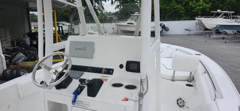 Slide: The Image of 2016 Sea Hunt Ultra 225 boat dashboard with steering wheel and Garmin navigation system. - 5