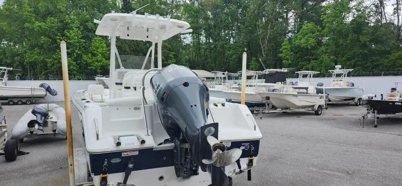 Slide: The Image of 2016 Sea Hunt Ultra 225 boat with outboard motor in a marina setting. - 6