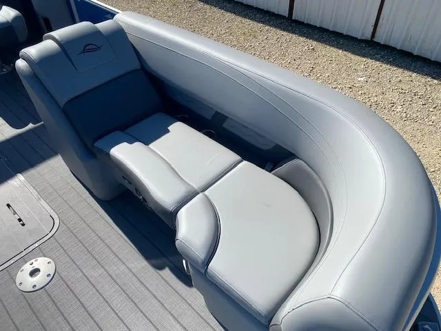 Slide: The Image of 2025 SunCatcher Fusion 322RC boat with luxurious gray seating and modern design. - 2