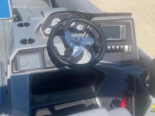 Slide: The Image of Cockpit of 2025 SunCatcher Fusion 322RC boat with steering wheel and control panel. - 5
