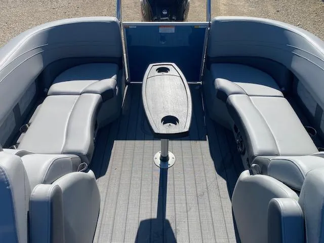 Slide: The Image of 2025 SunCatcher Fusion 322RC boat interior with gray seating and central table. - 8