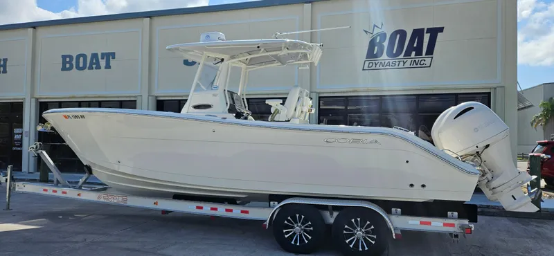 Slide: The Image of 2019 Cobia 280 Center Console boat on trailer at dealership. - 1