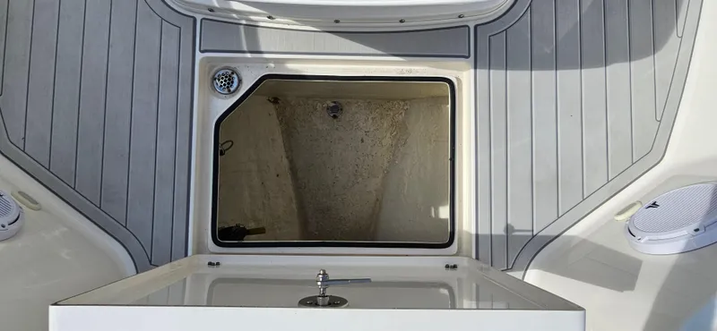 Slide: The Image of 2019 Cobia 280 Center Console boat deck with open storage compartment. - 13