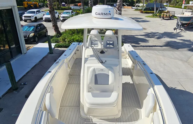 Slide: The Image of 2019 Cobia 280 Center Console boat with Garmin equipment, docked in a sunny marina. - 14
