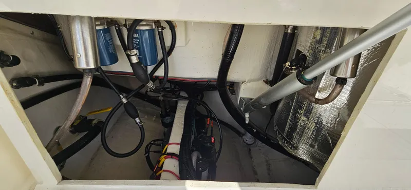 Slide: The Image of 2019 Cobia 280 Center Console engine compartment with hoses and filters visible. - 15