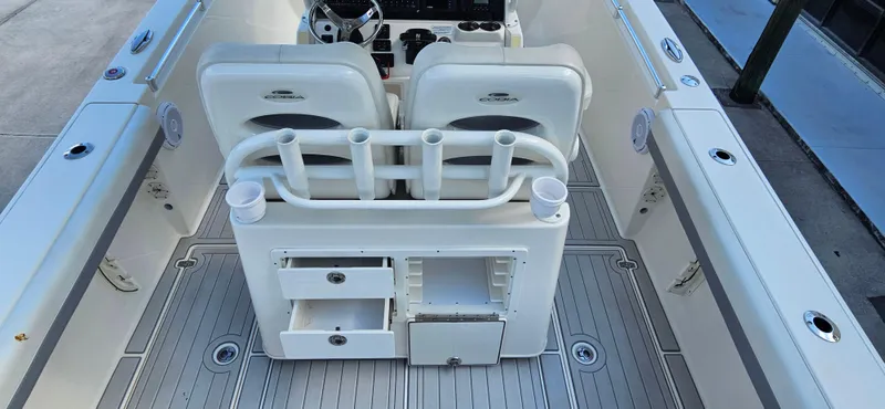 Slide: The Image of 2019 Cobia 280 Center Console boat interior with seating and storage compartments. - 18
