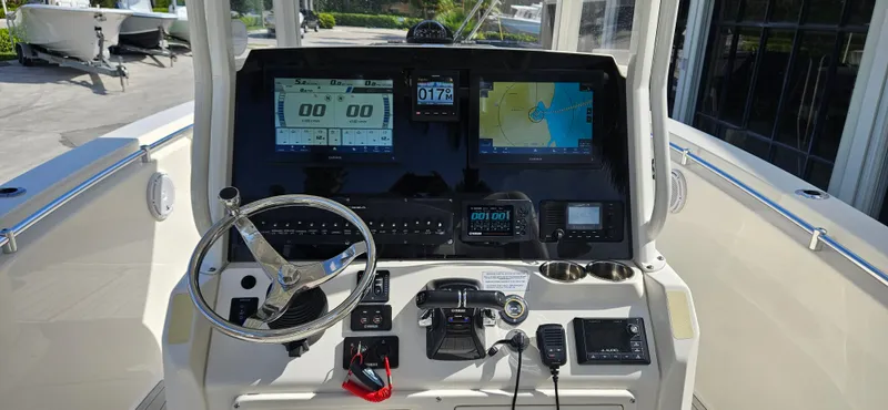 Slide: The Image of 2019 Cobia 280 Center Console dashboard with navigation screens and steering wheel. - 5