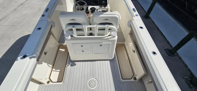 Slide: The Image of 2019 Cobia 280 Center Console boat interior with seating and storage compartments. - 7